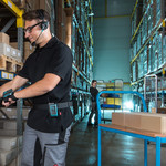 Warehouse worker is picking from the shelf with the help of Lydia Voice software.